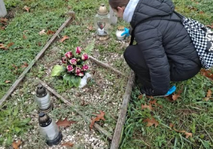 Dziewczynka stawiająca znicz