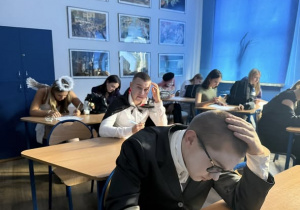 Uczniowie siedzący w sali podczas konkursu "Dziady kontra Halloween"